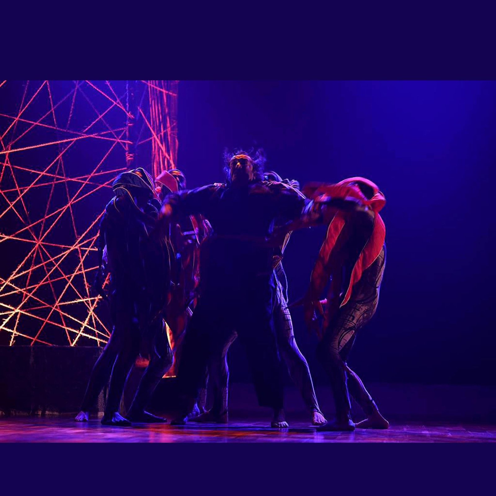 Lead performer with arms outstretched
